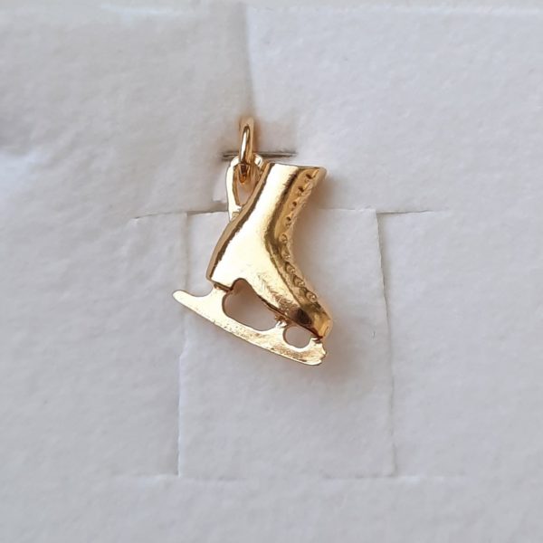 gold-plated pendant in the shape of a skate